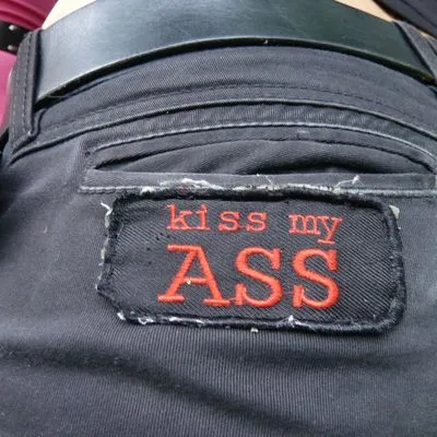 Jean with a patch reading "Kiss my ass" 