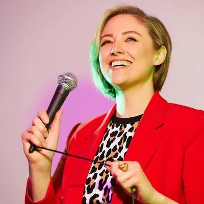 Picture of Katie Martell holding a microphone