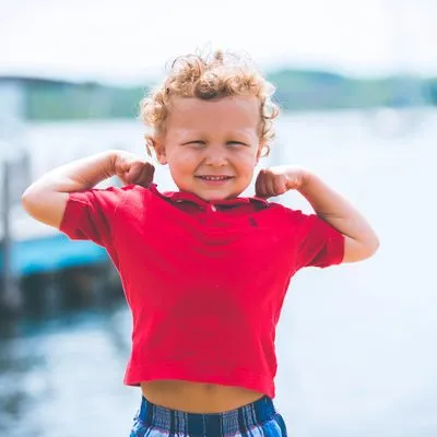 Little boy flexing his muscles 