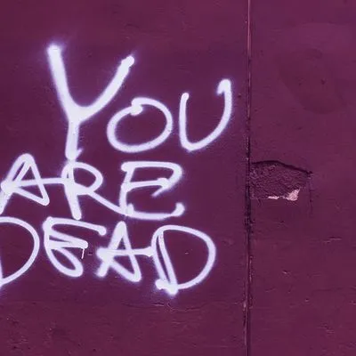 Spray paint reading "You are dead" 