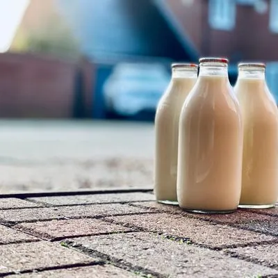 Three glass milk bottles waiting on the doorstep.
