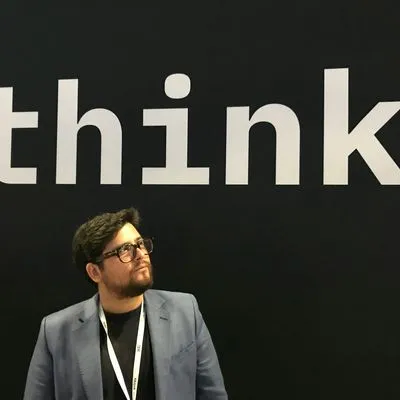 A guy stood in front of the word, "think"