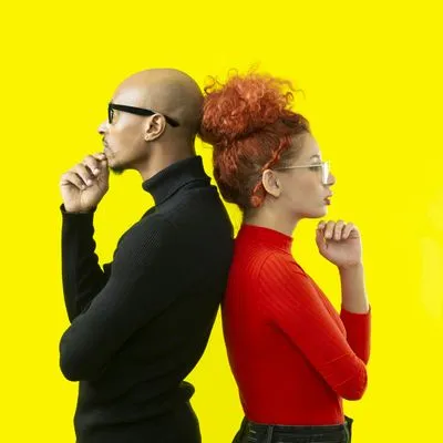 Man and women stood back to back with their hand under their chin, thinking. 