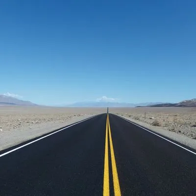 A road in the middle of the dessert. Photo by Ilse Orsel on Unsplash