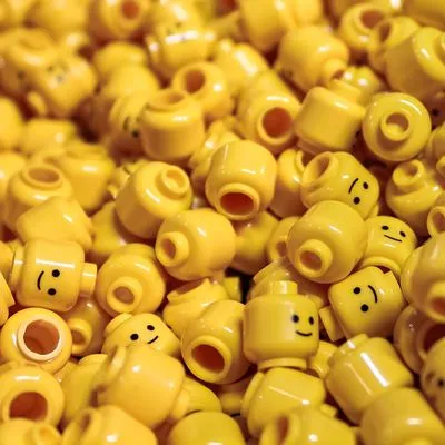 Hundreds of yellow lego plastic toy heads