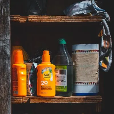 Open cabinet with bottles of suncream instead