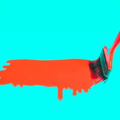 Big paint brush dripping red paint on a blue background.