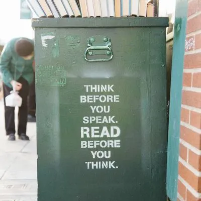 Bin with spray paint reading "think before you speak. read before you think" 