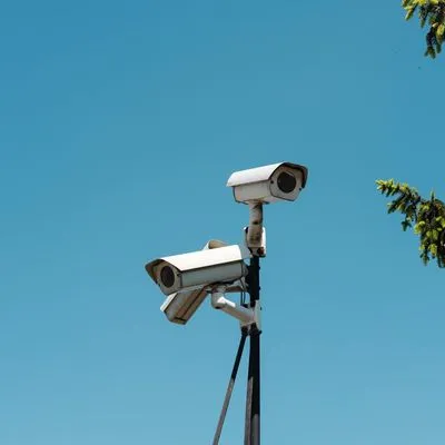 CCTV cameras against a blue sky.