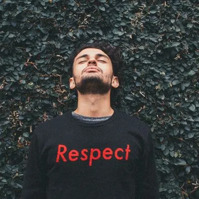 Guy wearing a tshirt with the word Respect written on it