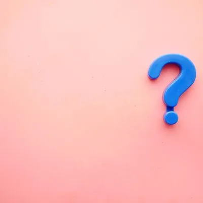 Pink background with a blue question mark.