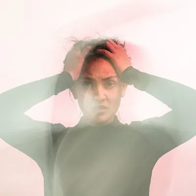 Lady holding her head looking confused and frustrated