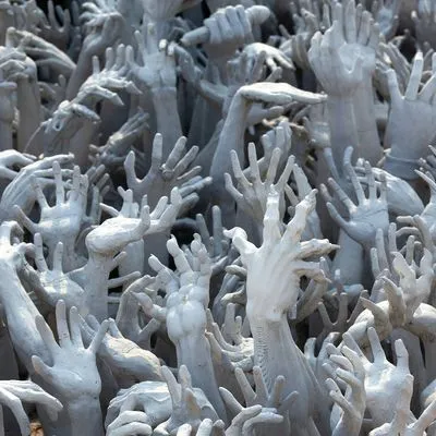 A sea of grey hands coming up out of the ground fighting to emerge. Some have long nails or claws.