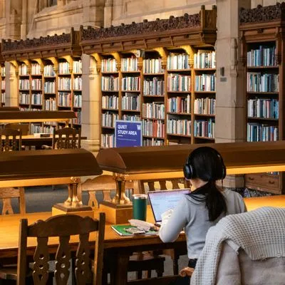 A women sat in an old library 